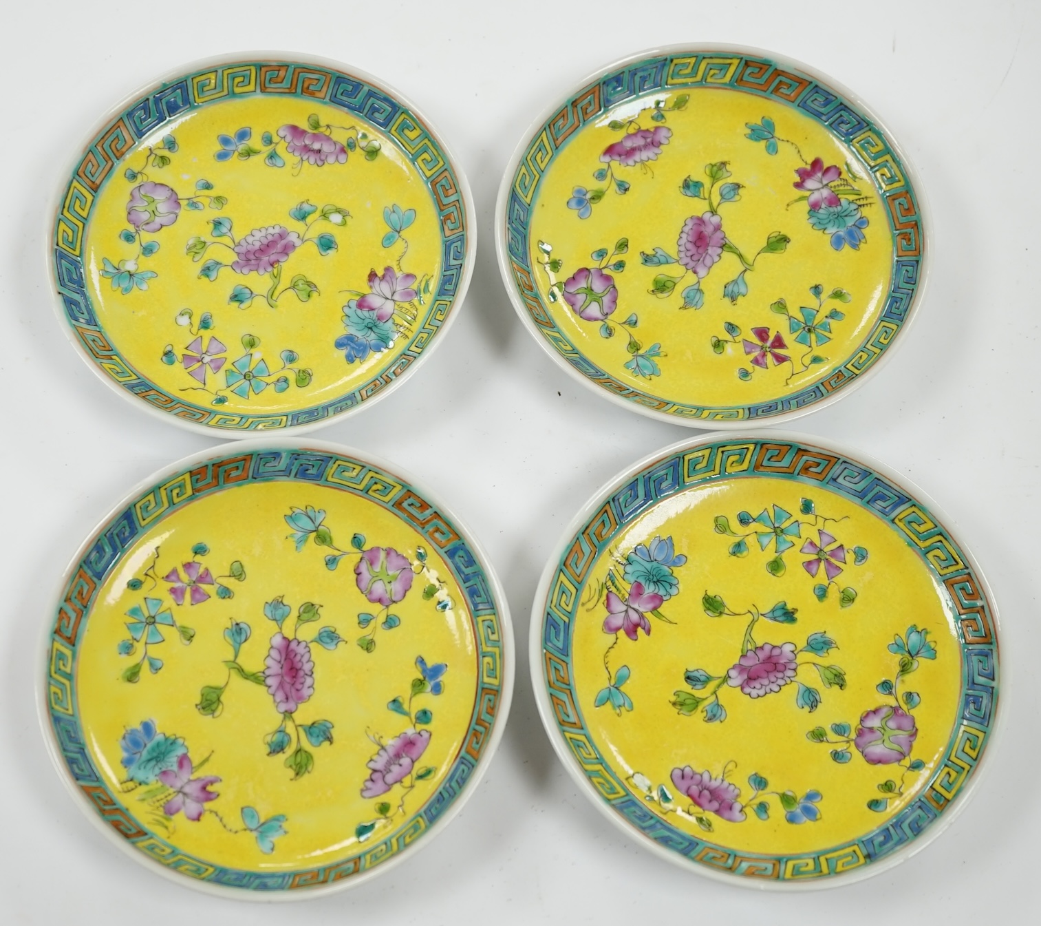 Four Chinese yellow ground saucer dishes, Republic period, 13.5cm diameter. Condition - good